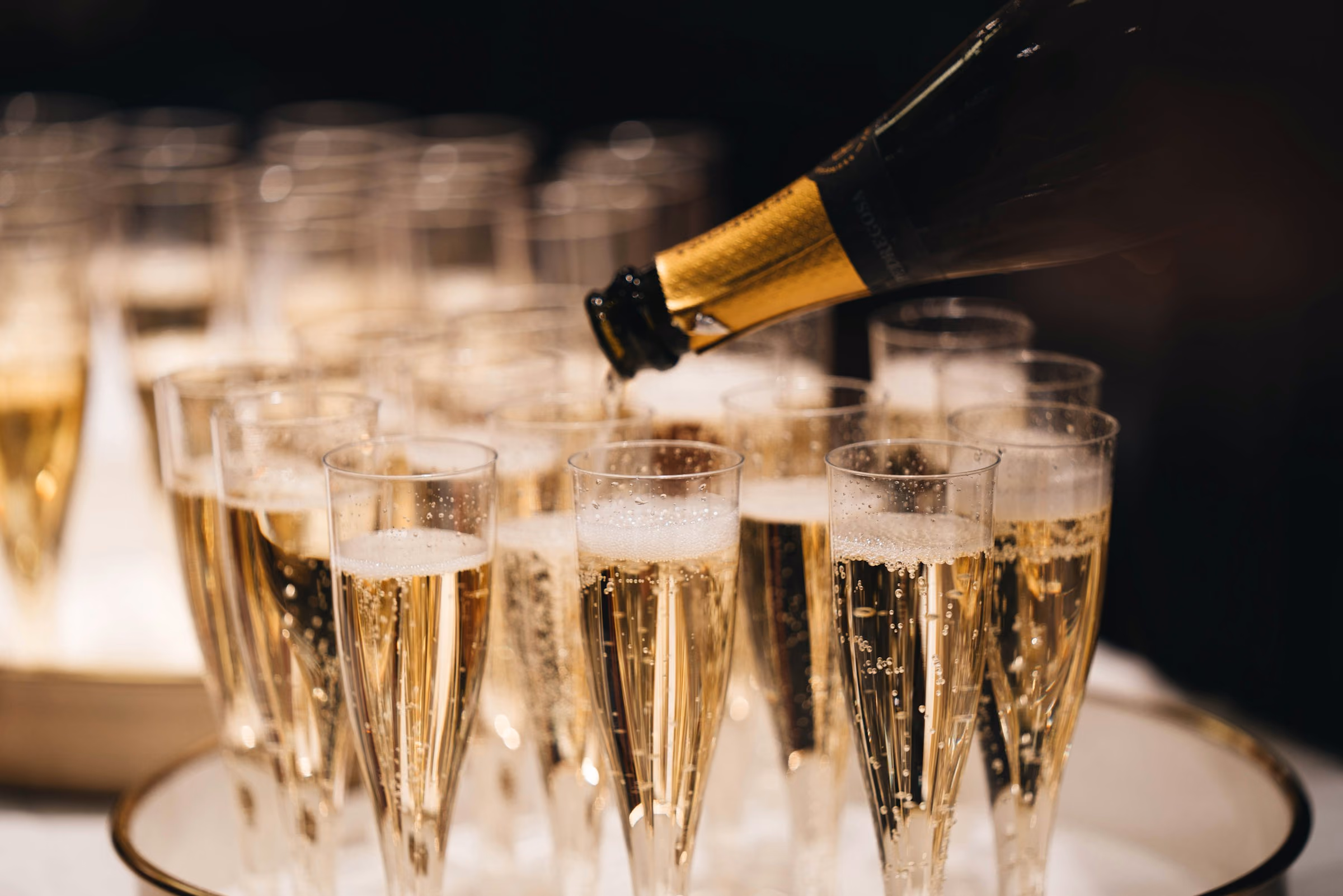 Champagne poured into a pyramid of flutes