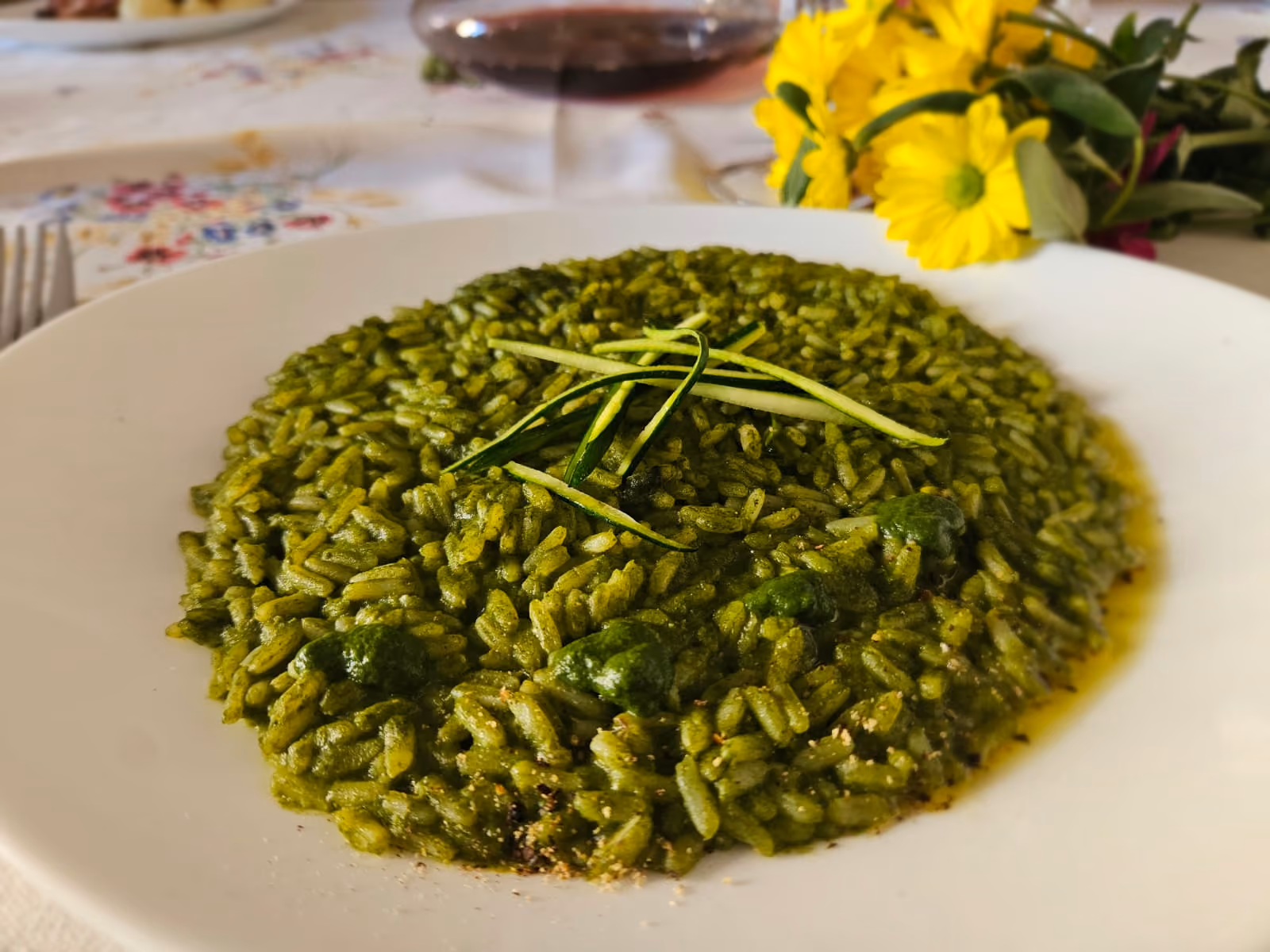 Green courgette risotto with ribbons of raw courgette