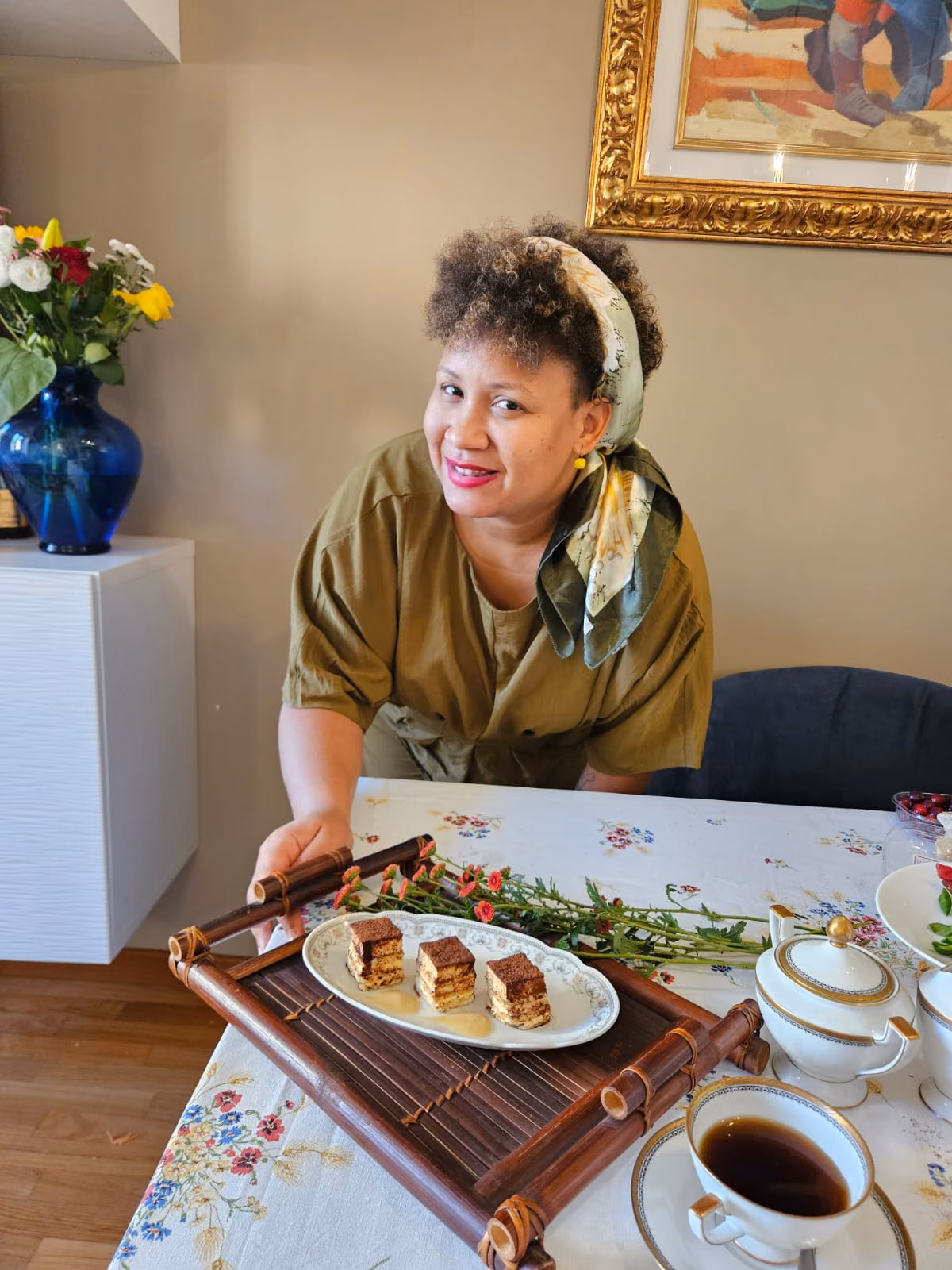 Hemi Castillo serving a tray of tiramisù at a dining table