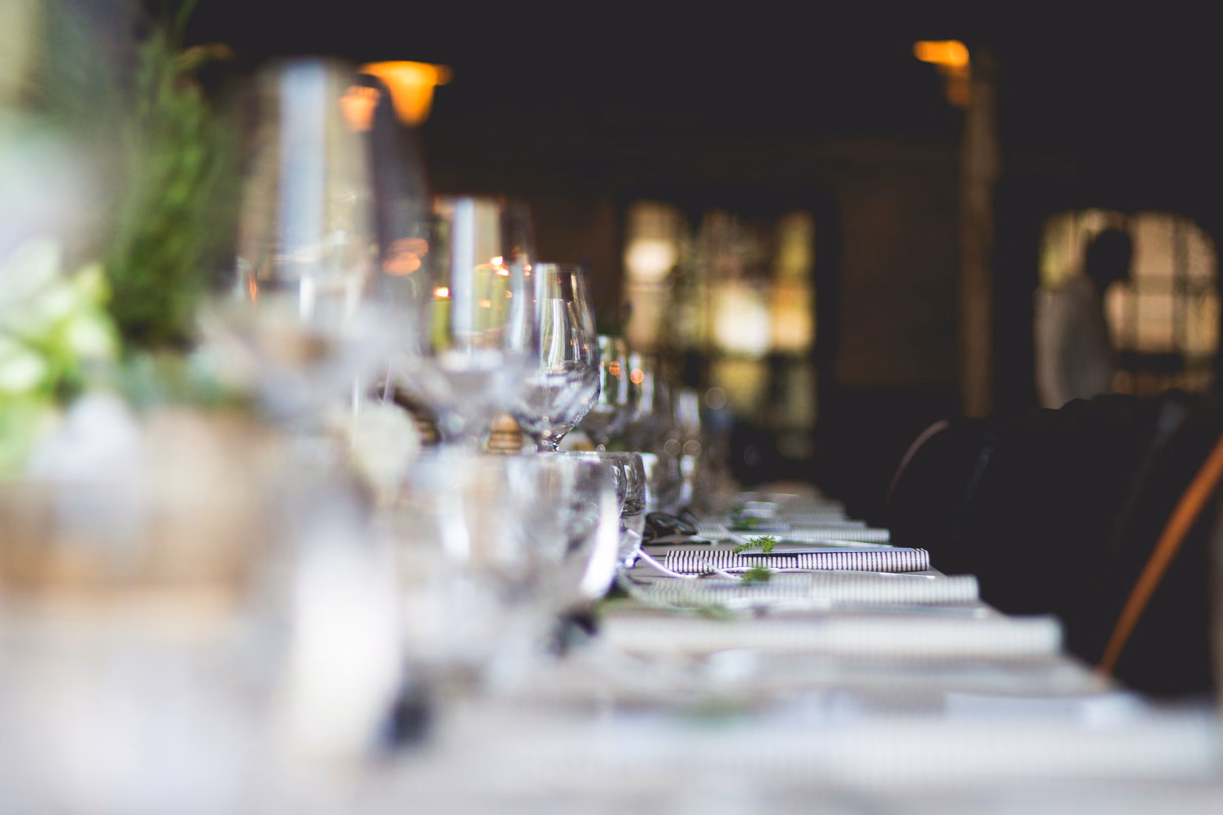 Long table of crystal glasses before service