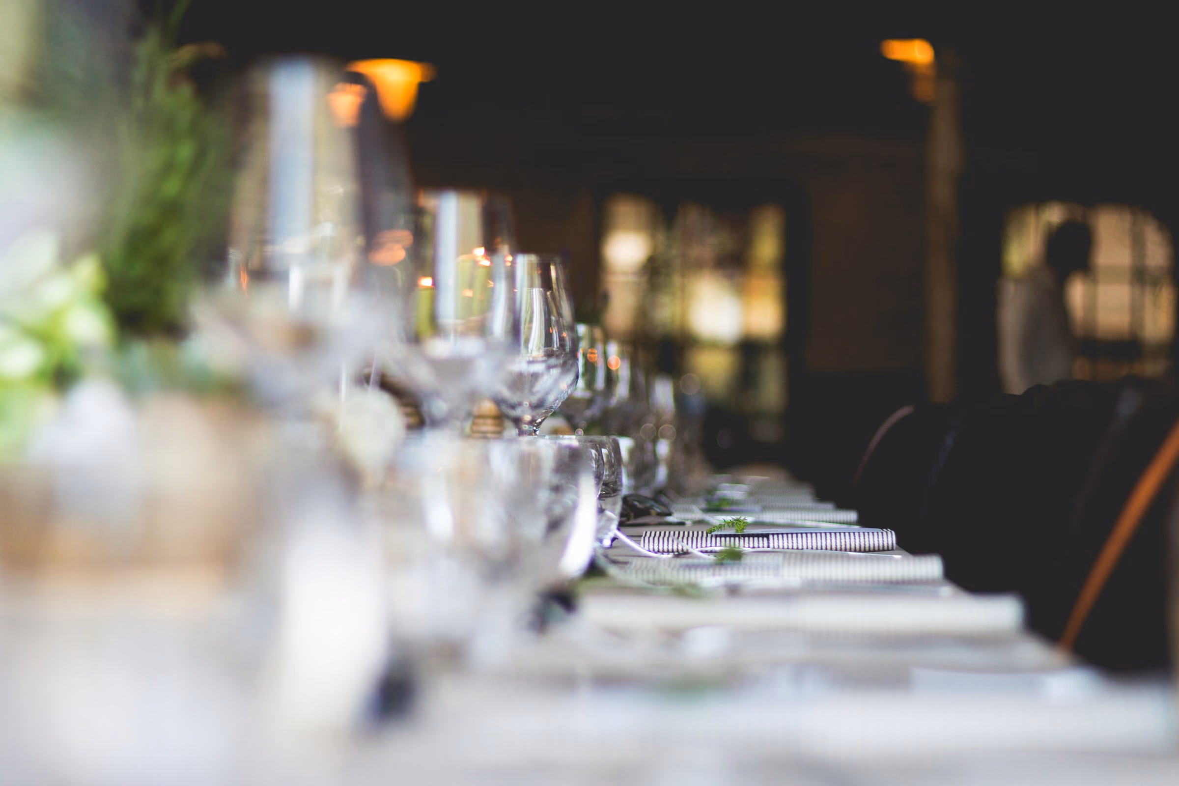 Long table of crystal glasses before service