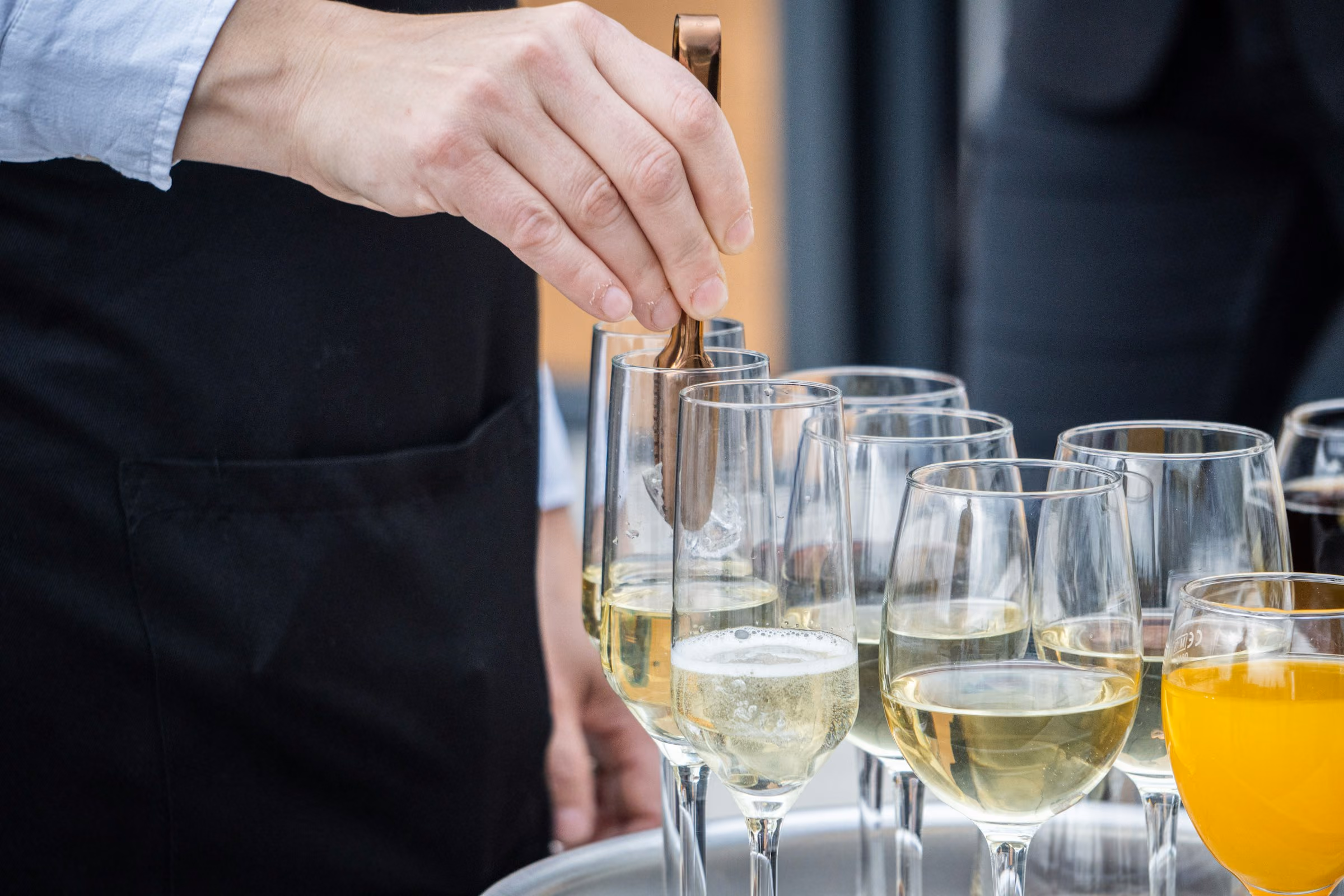 White wine poured for guests at a reception